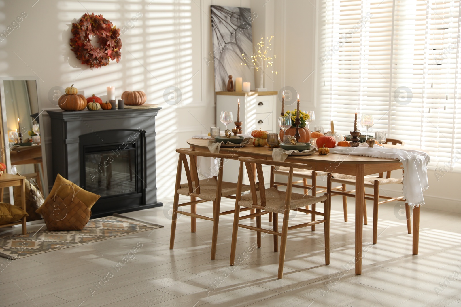 Photo of Stylish dining room with beautiful table setting and autumn decor