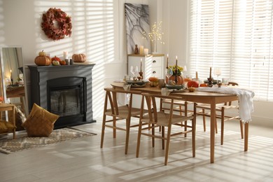 Stylish dining room with beautiful table setting and autumn decor