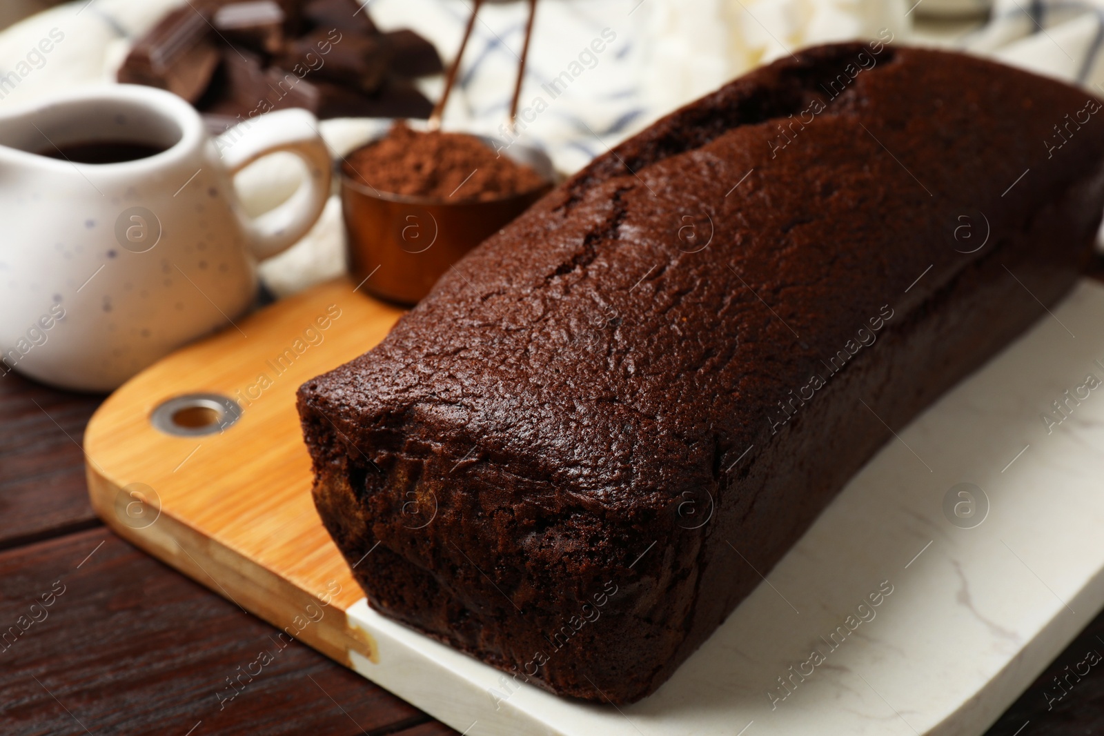 Photo of Tasty chocolate sponge cake on wooden table, closeup