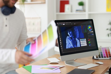 Photo of Designer with color palette in office, closeup