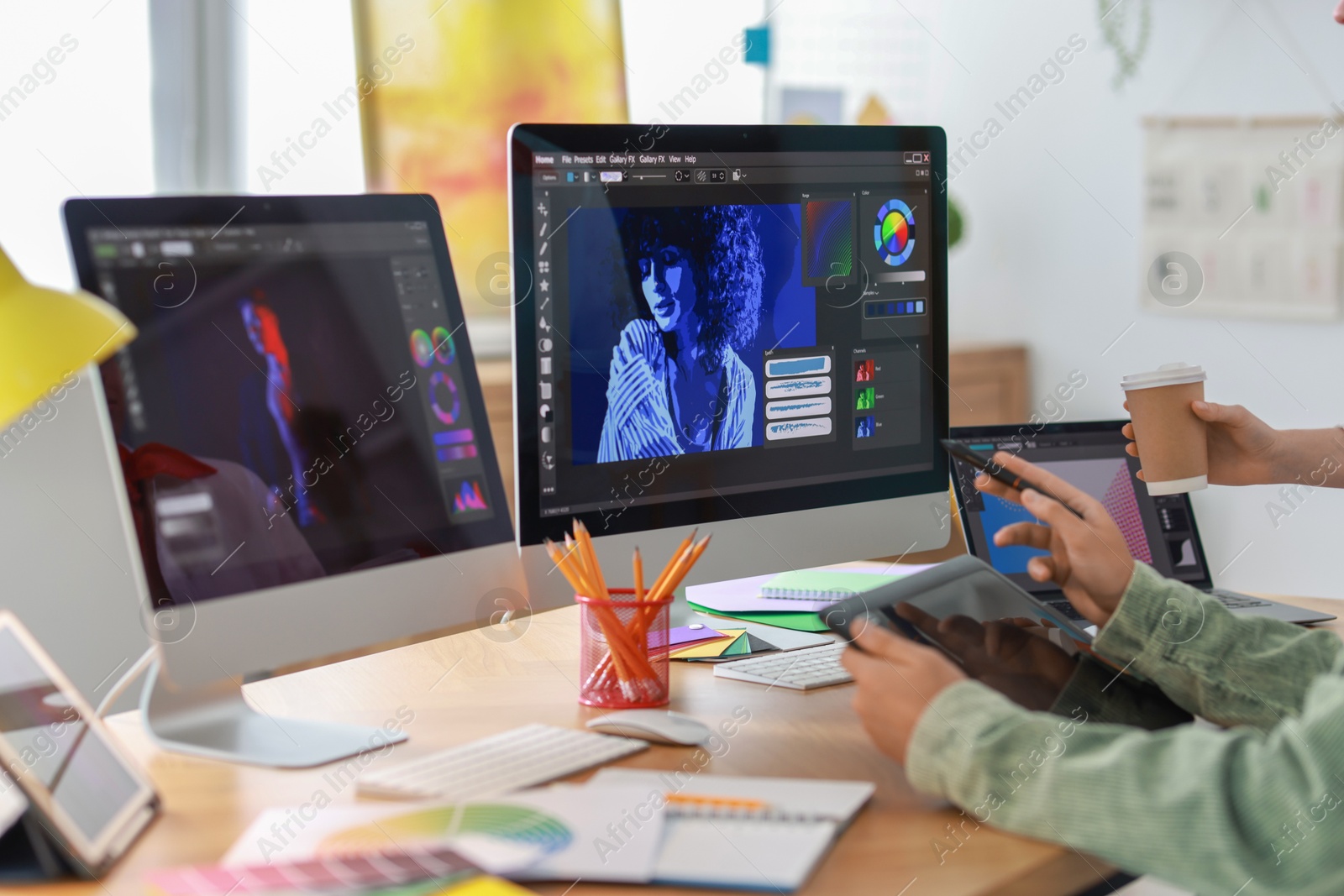 Photo of Designers working at table together in office, closeup