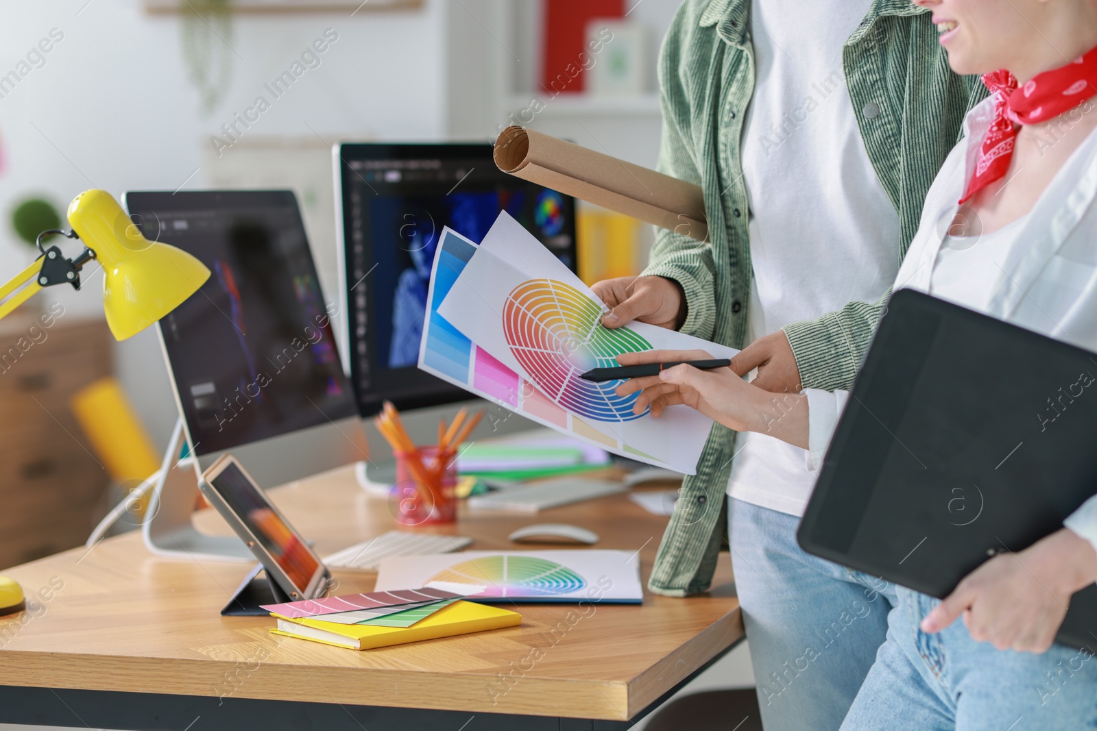 Photo of Designers with tablet and color palette working together in office, closeup