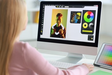 Graphic designer working with computer at table in office