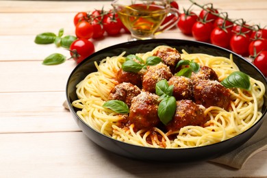 Delicious pasta with meatballs on wooden table, closeup