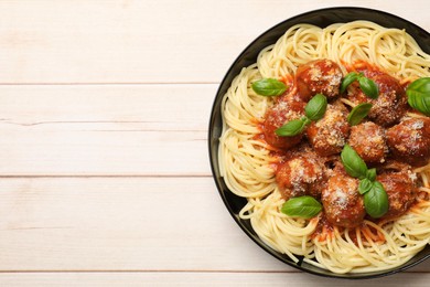 Delicious pasta with meatballs on wooden table, top view. Space for text