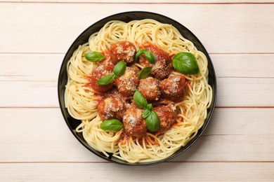 Delicious pasta with meatballs on wooden table, top view