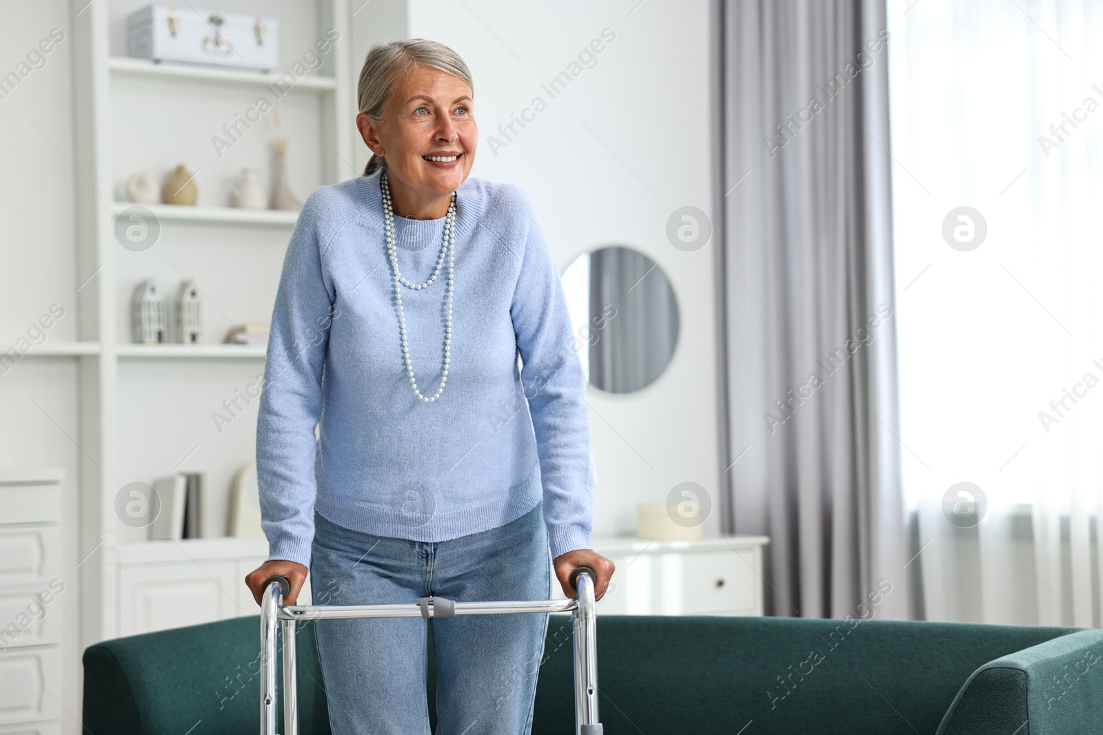 Photo of Senior woman with walking frame at home