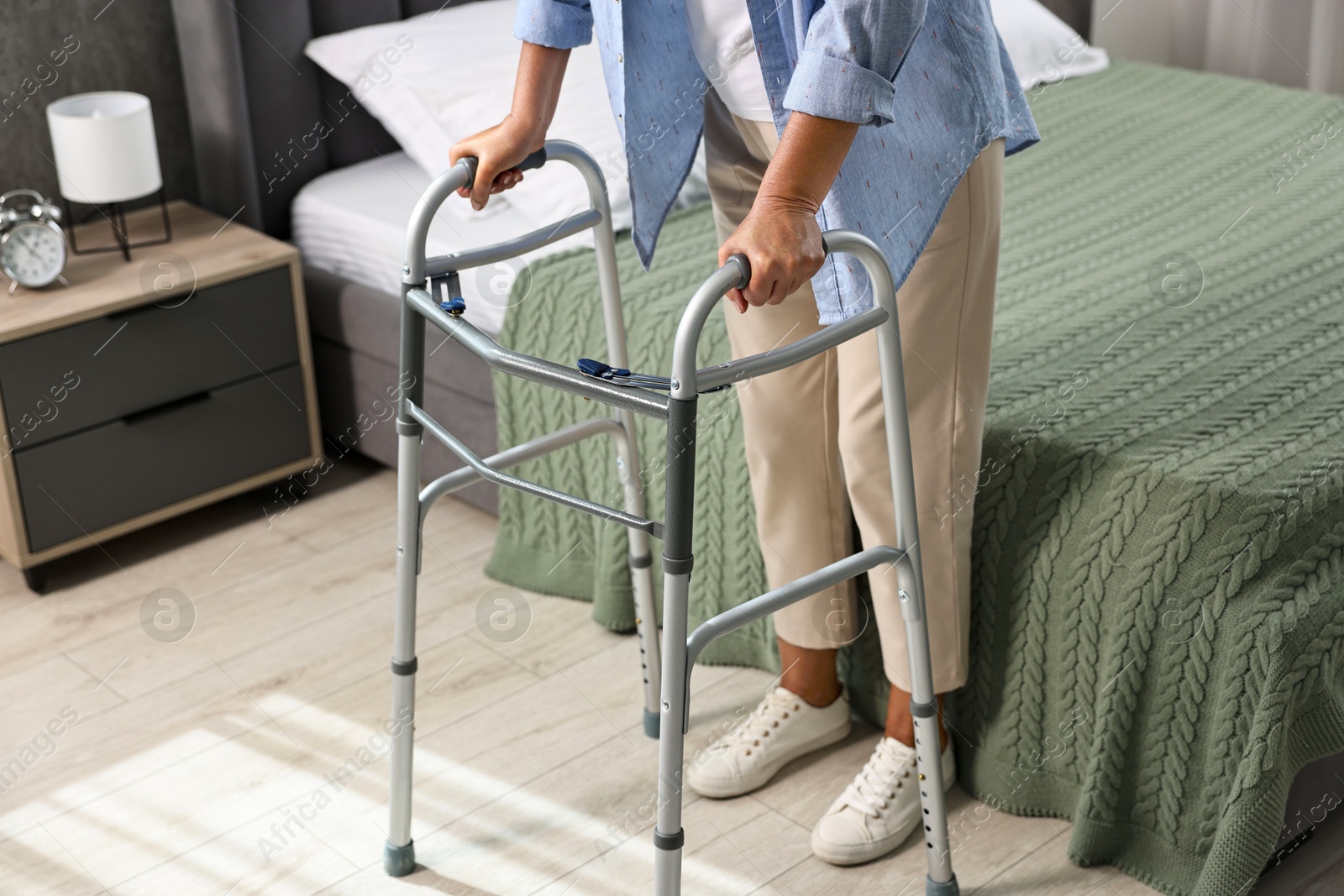 Photo of Senior woman with walking frame at home, closeup