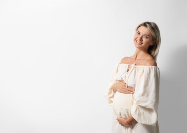 Photo of Portrait of beautiful pregnant woman on white background, space for text