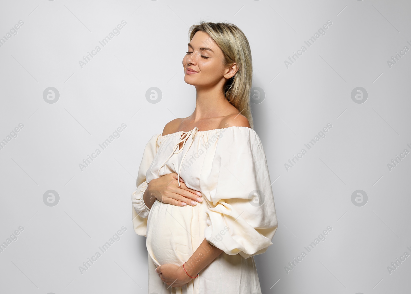 Photo of Portrait of beautiful pregnant woman on white background