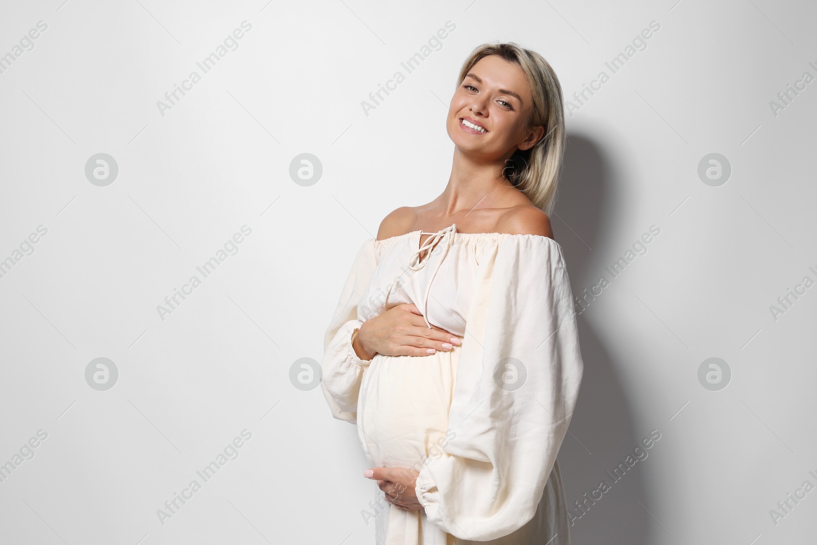 Photo of Portrait of beautiful pregnant woman on white background