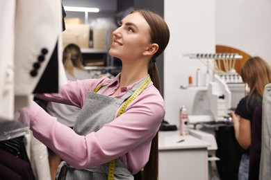 Atelier. Young woman working in professional workshop