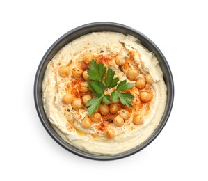 Photo of Delicious hummus with parsley, paprika and chickpeas in bowl isolated on white, top view