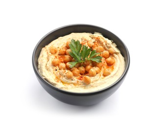 Photo of Delicious hummus with parsley, paprika and chickpeas in bowl isolated on white