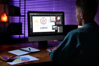 Designer working on computer indoors at night