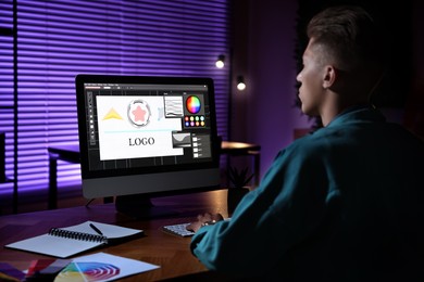 Photo of Designer working on computer indoors at night