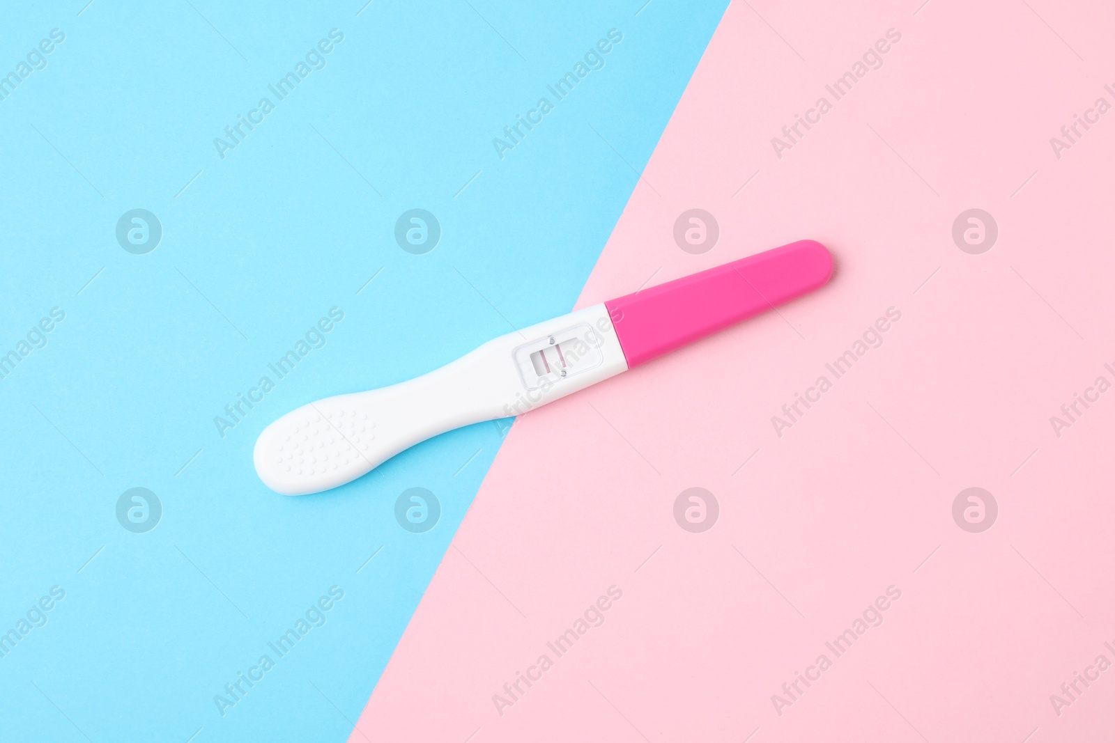 Photo of One pregnancy test on color background, top view