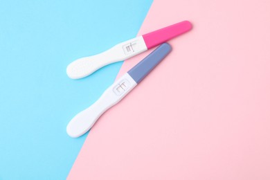 Photo of Two pregnancy tests on color background, top view. Space for text