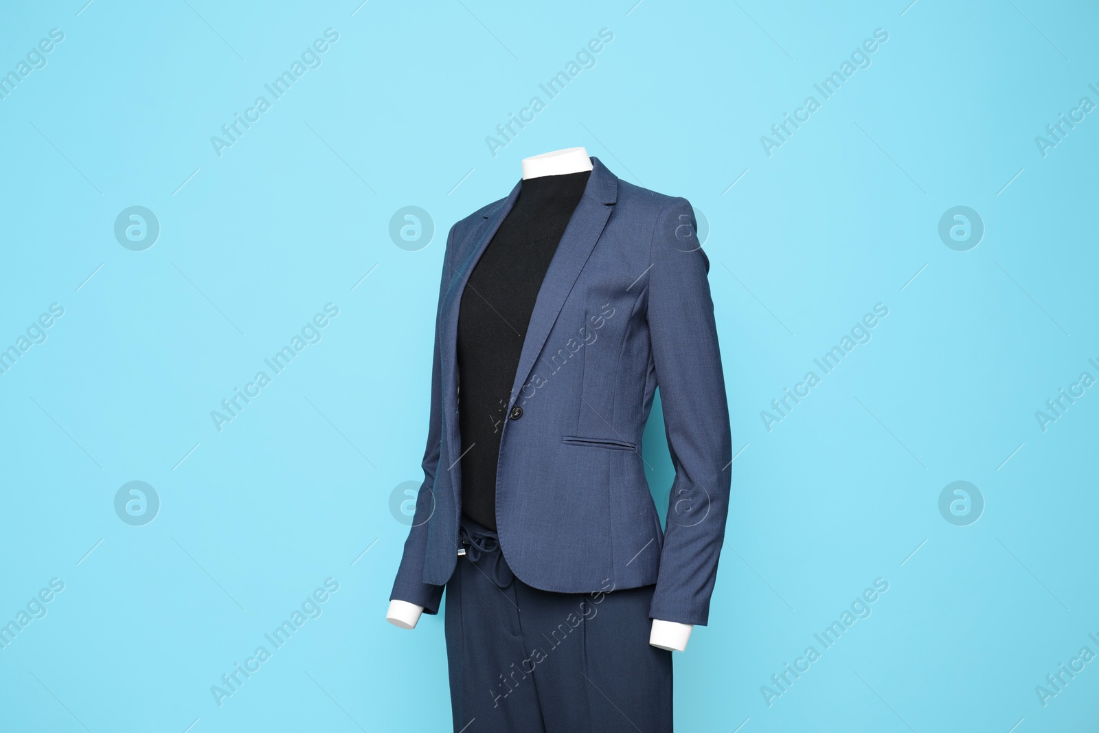 Photo of Female mannequin with stylish suit on light blue background