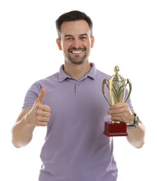 Photo of Happy winner with golden trophy cup showing thumbs up on white background