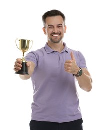 Photo of Happy winner with golden trophy cup showing thumbs up on white background