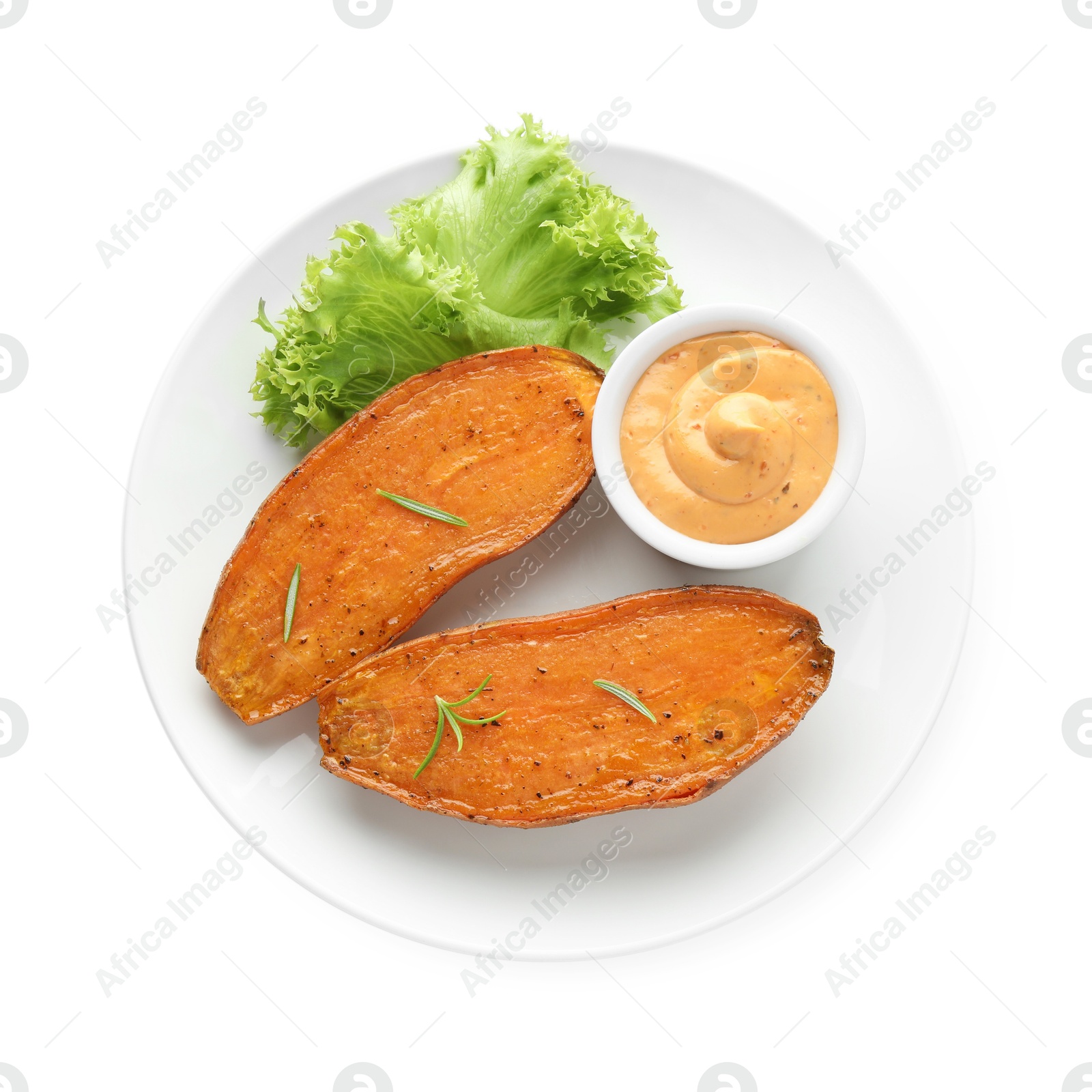 Photo of Halves of tasty cooked sweet potato with rosemary, lettuce and sauce isolated on white, top view