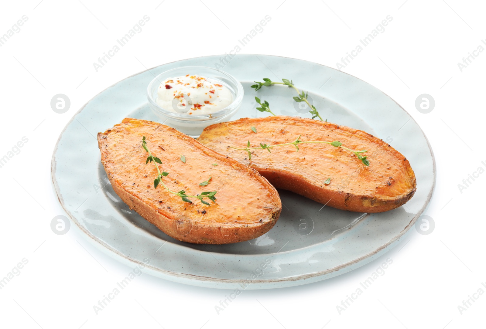 Photo of Halves of tasty cooked sweet potato with thyme and sauce isolated on white