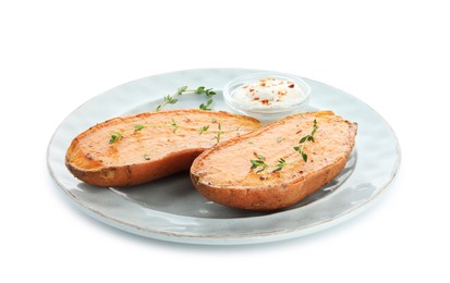 Photo of Halves of tasty cooked sweet potato with thyme and sauce isolated on white