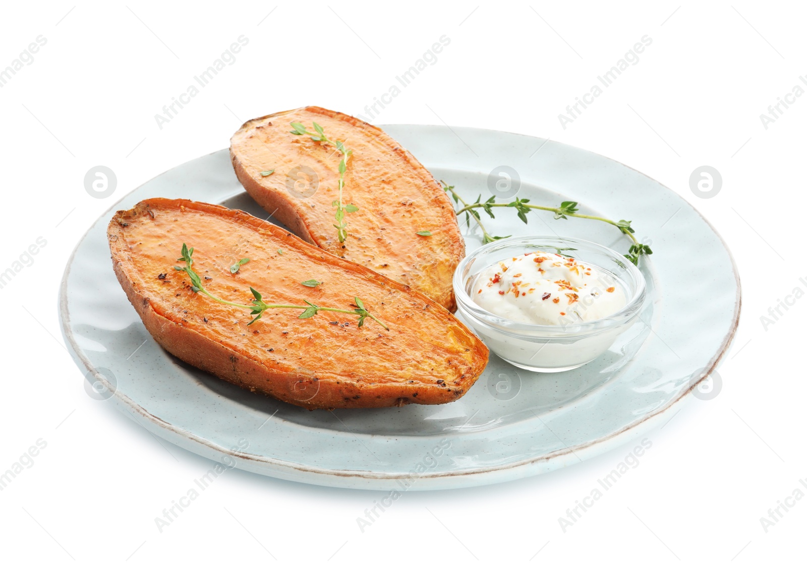 Photo of Halves of tasty cooked sweet potato with thyme and sauce isolated on white