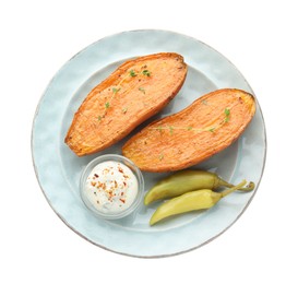 Photo of Halves of tasty cooked sweet potato with thyme, pickled peppers and sauce isolated on white, top view