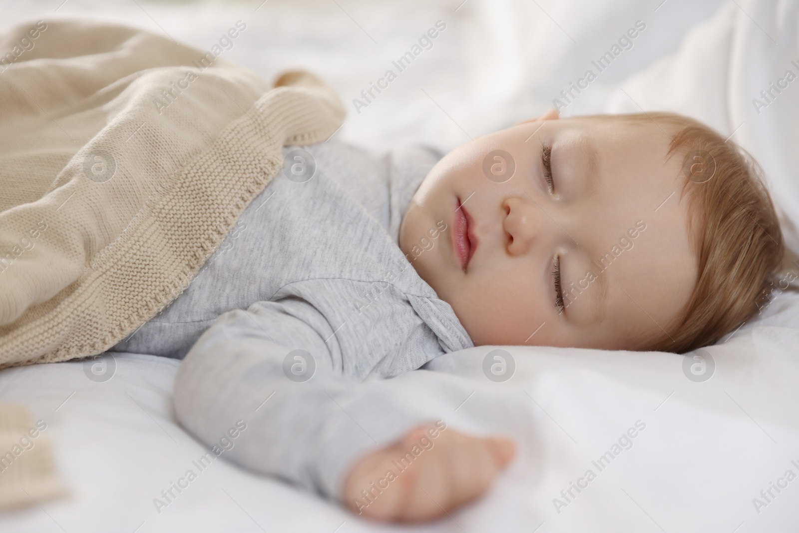 Photo of Cute little baby sleeping on bed at home