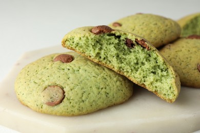 Photo of Delicious mint chocolate chip cookies on white table, closeup