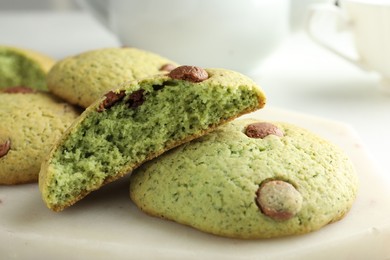 Photo of Delicious mint chocolate chip cookies on white table, closeup