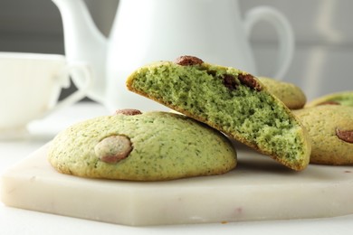 Photo of Delicious mint chocolate chip cookies on white table, closeup