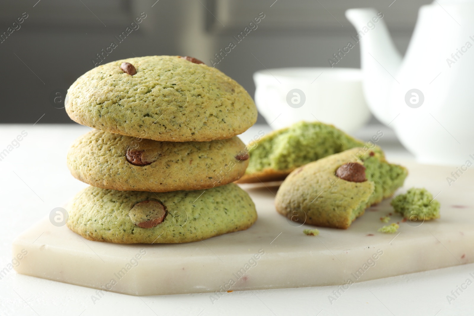 Photo of Delicious mint chocolate chip cookies on white table, closeup