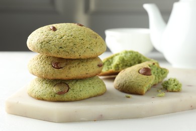 Photo of Delicious mint chocolate chip cookies on white table, closeup