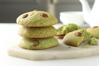 Delicious mint chocolate chip cookies on white table, closeup