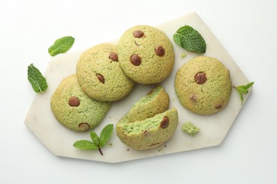 Photo of Delicious mint chocolate chip cookies on white table, top view