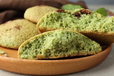 Photo of Delicious mint chocolate chip cookies on light table, closeup