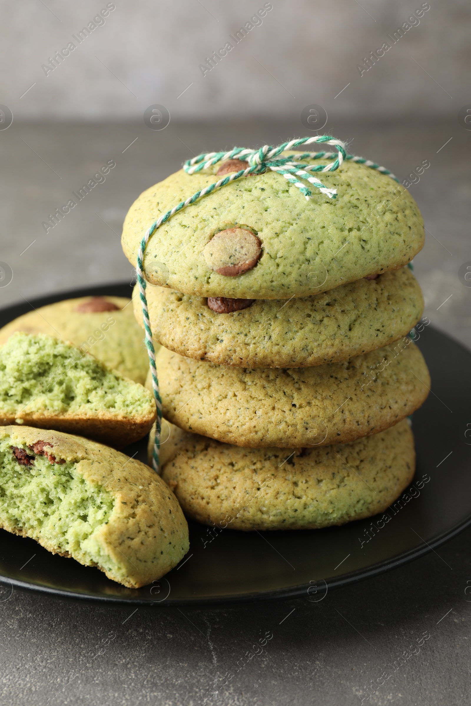 Photo of Delicious mint chocolate chip cookies on grey table, closeup