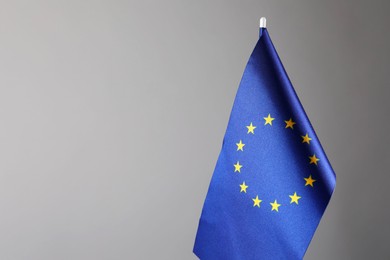 Photo of One flag of European Union on grey background. Space for text