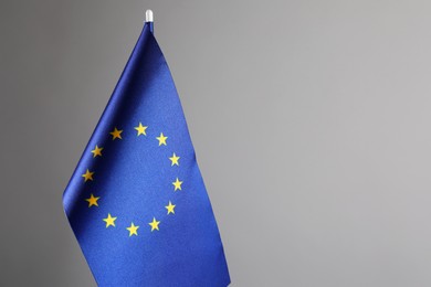 Photo of One flag of European Union on grey background. Space for text