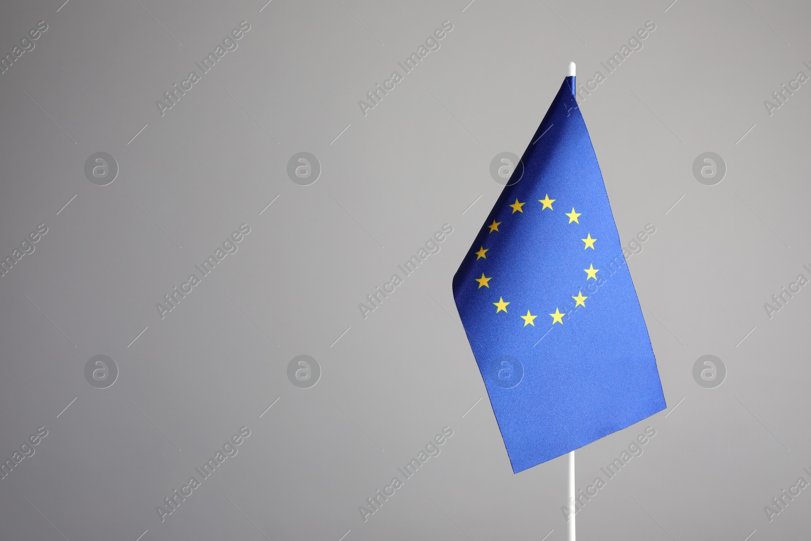 Photo of One flag of European Union on grey background. Space for text