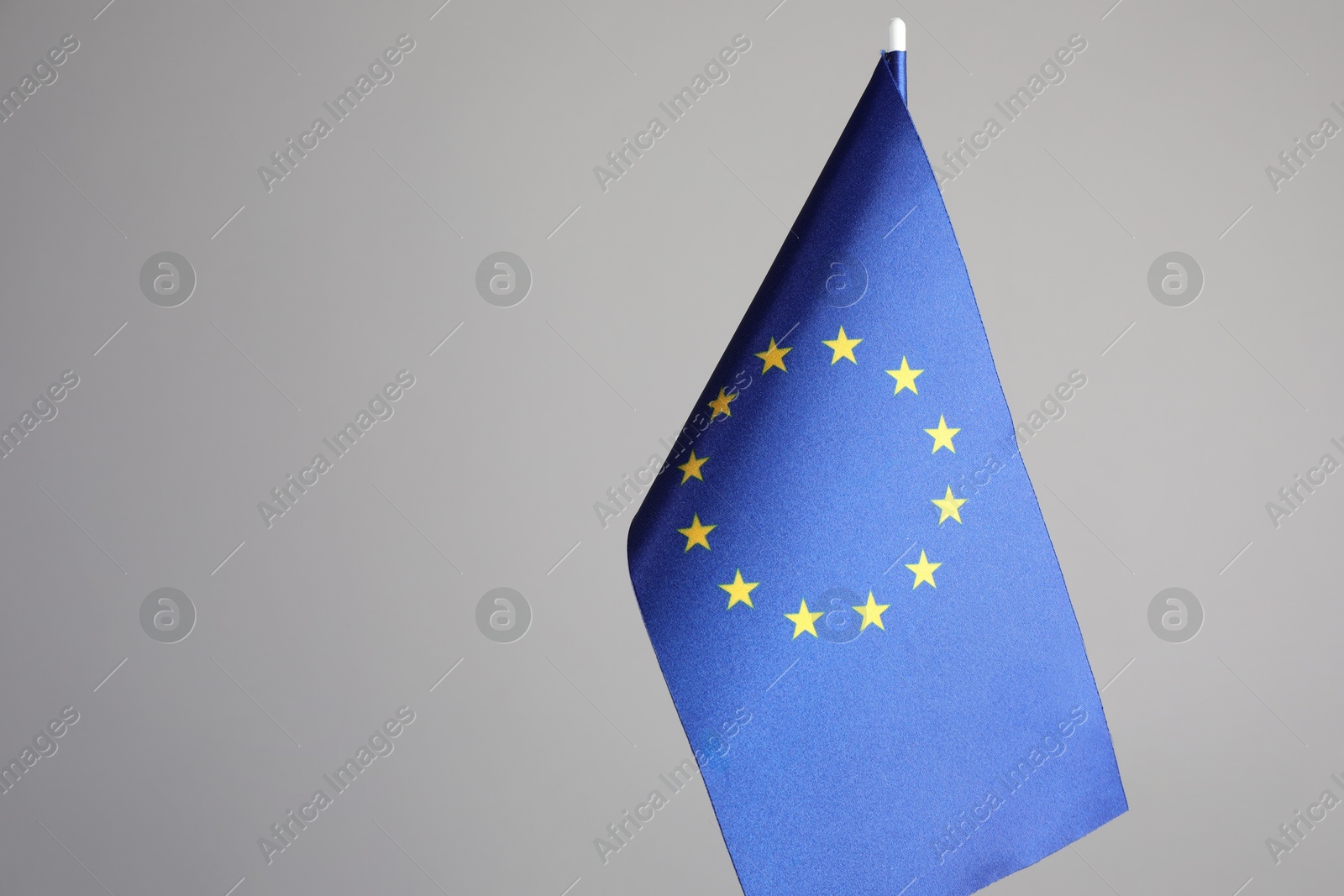 Photo of One flag of European Union on grey background. Space for text