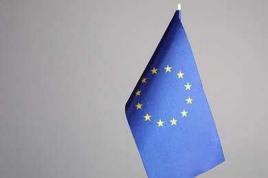 Photo of One flag of European Union on grey background. Space for text