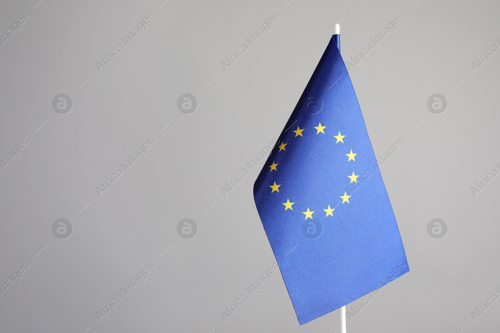 Photo of One flag of European Union on grey background. Space for text