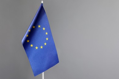 Photo of One flag of European Union on grey background. Space for text