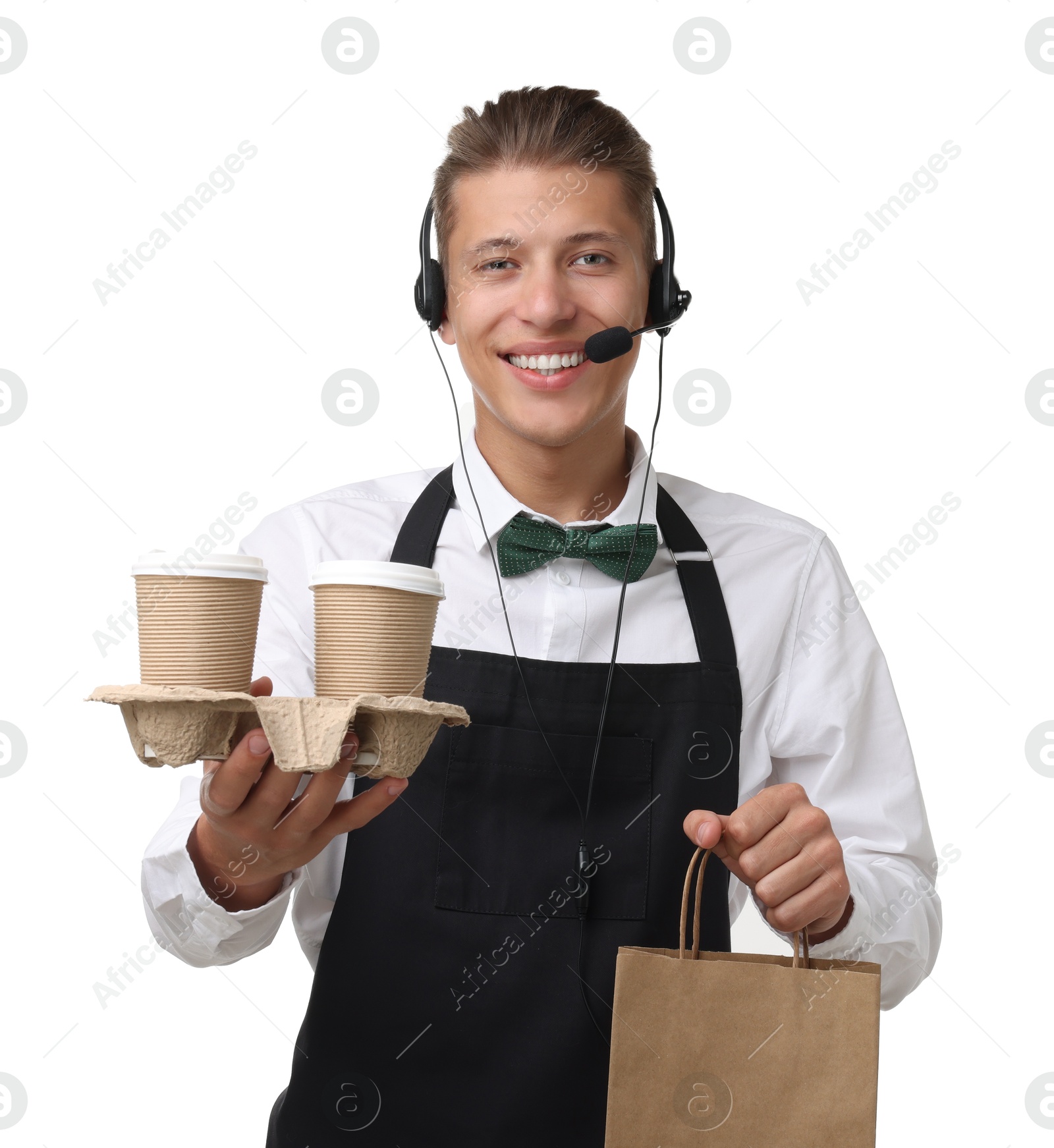 Photo of Fast-food worker with paper bag and cups on white background