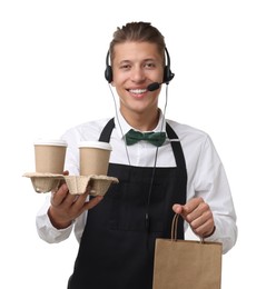 Photo of Fast-food worker with paper bag and cups on white background