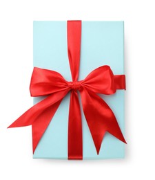 Photo of Beautiful gift box with red bow isolated on white, top view